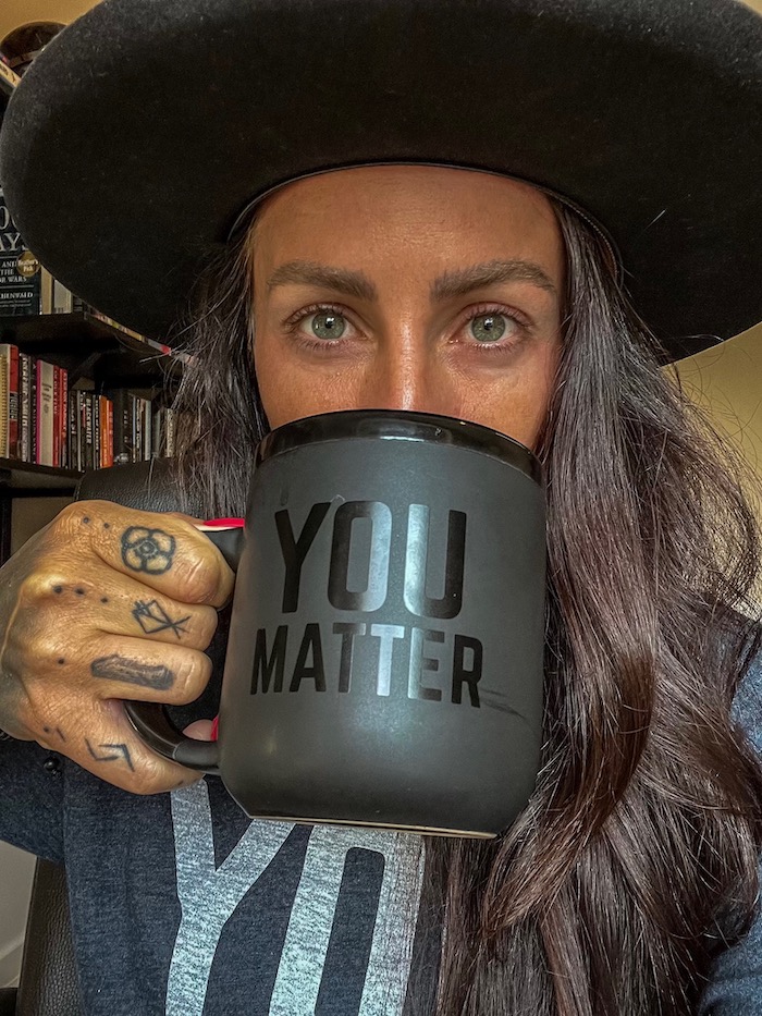 Canadian Veteran holds a YOU MATTER cup while wearing YOU MATTER tee in support of Veteran mental health.